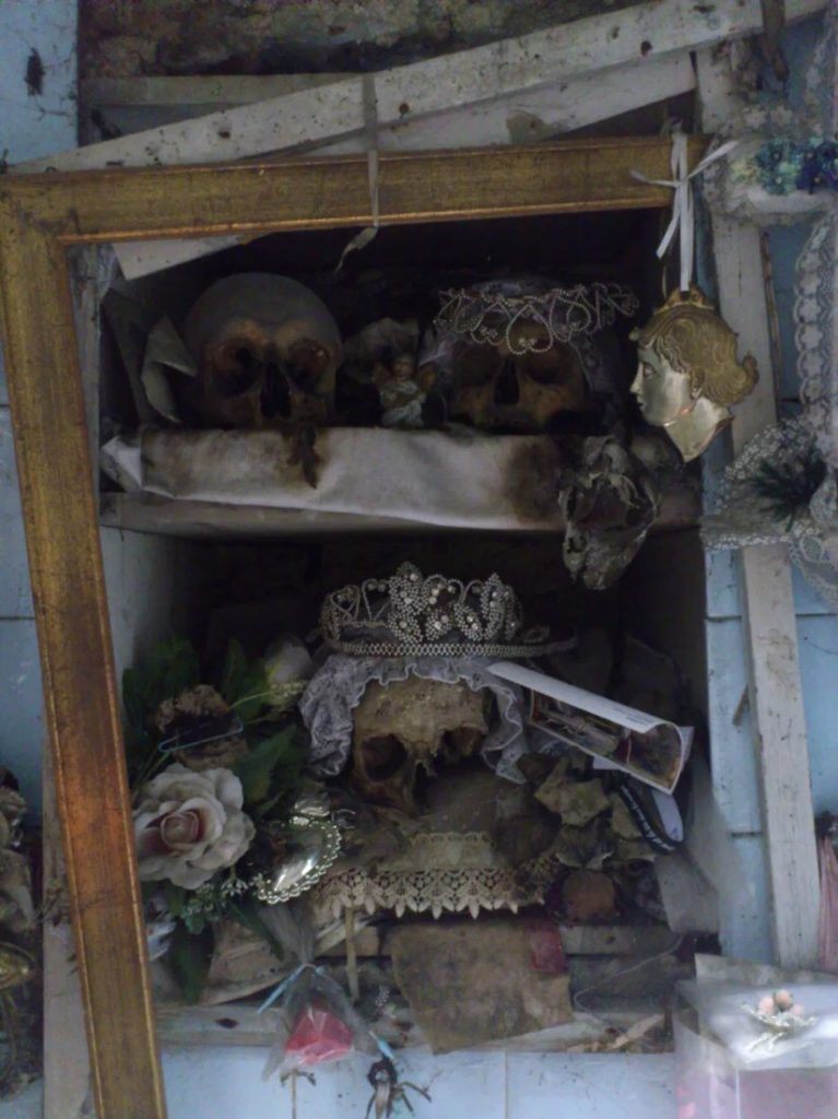 The skull of Lucia at the Chiesa delle Anime del Purgatorio ad Arco, wearing a bridal veil and crown, surrounded by flowers