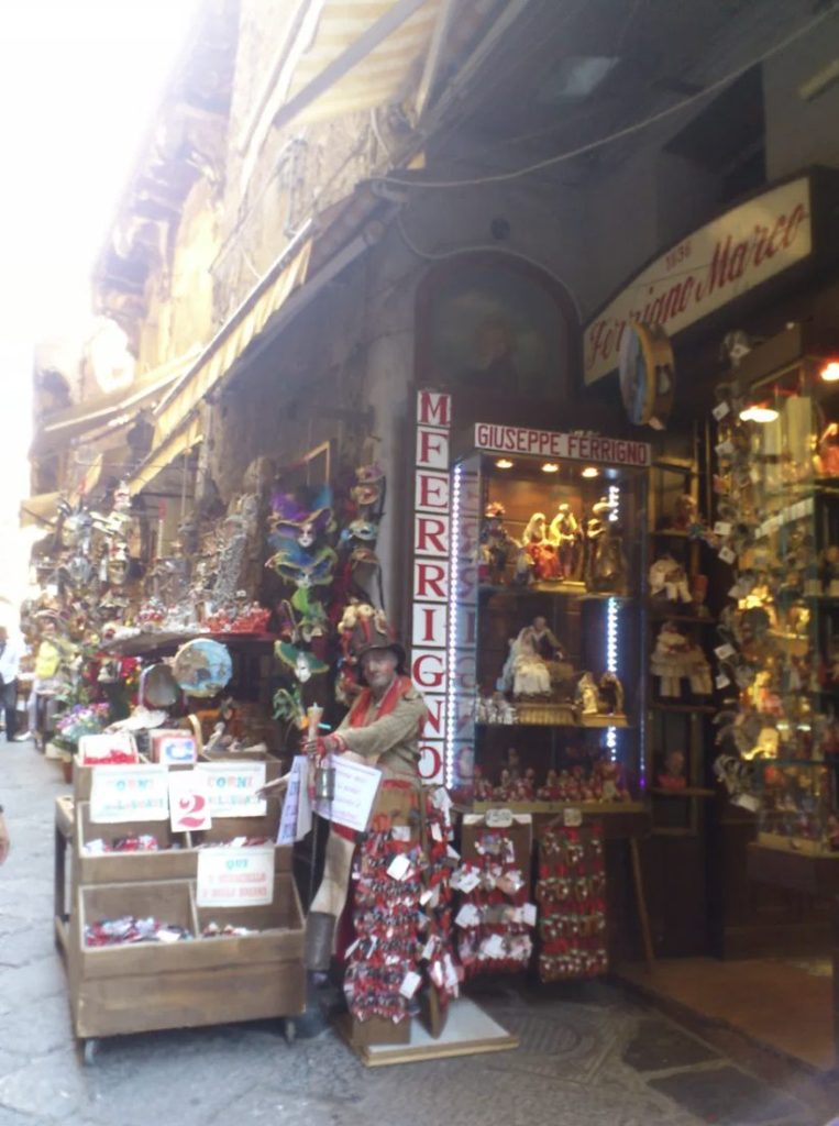 Racks of red cornicelli lucky horns for sale outside a shop in Naples