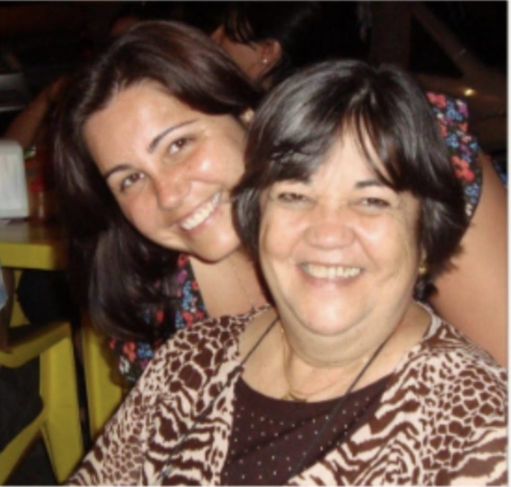 Daniela Pescuma smiling with her mother, arms around each other